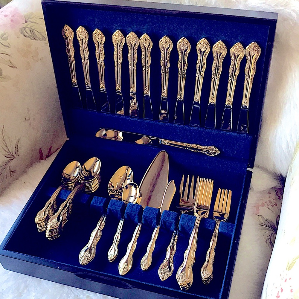 Gold tone flatware for 12 formal placesettings, plus more, by International.